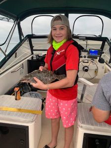 Beginner Kid With His First Flounder in New Jersey